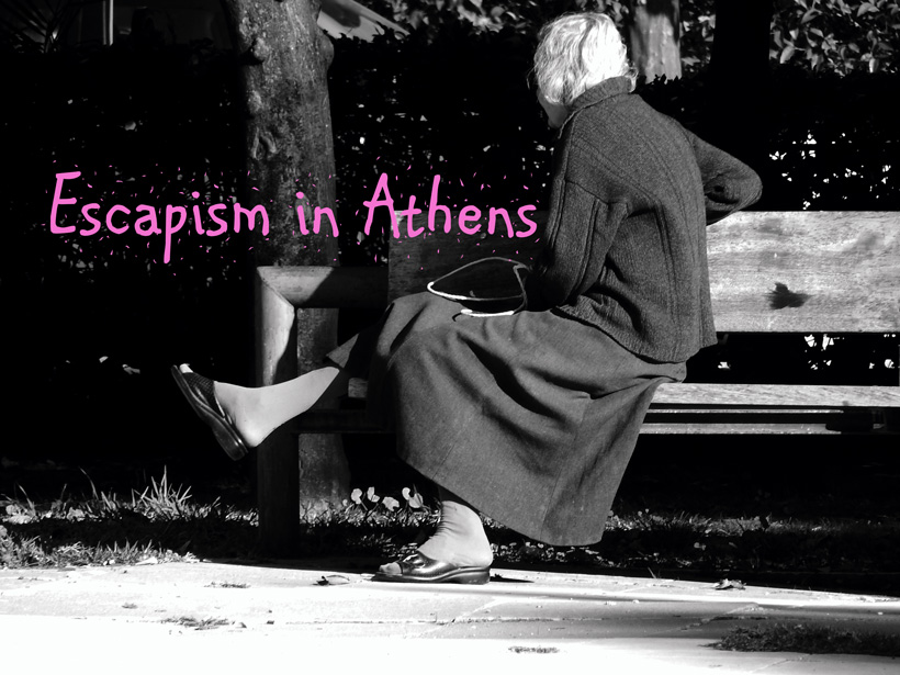 Black and white photo: Woman sitting cross-legged on a bench, facing away